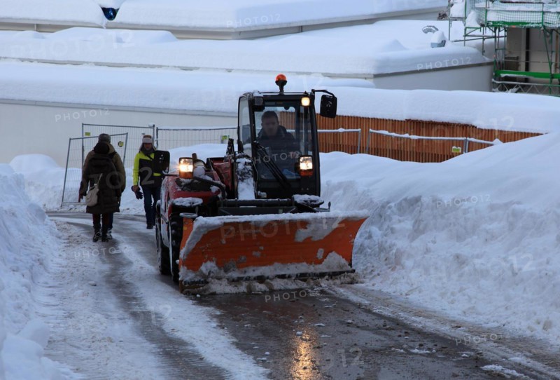 Winter service with snow plough on a country road in Upper Bavaria