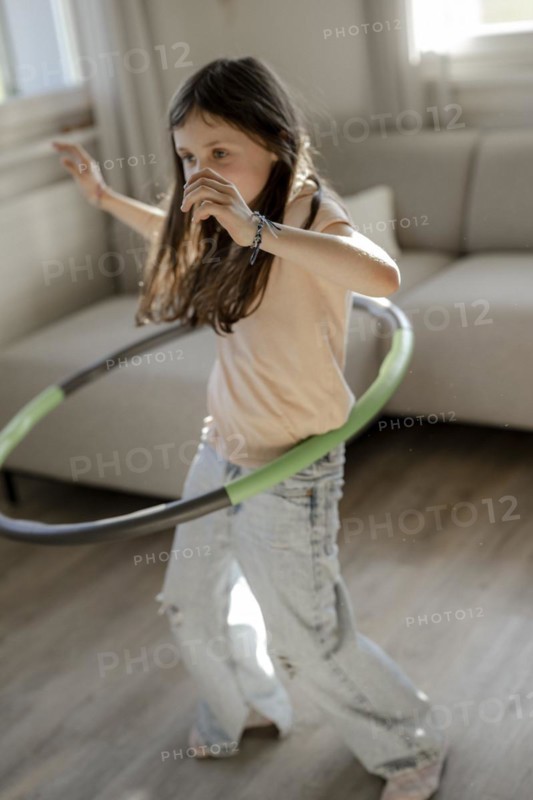 Girl gymnastics with hula hoop