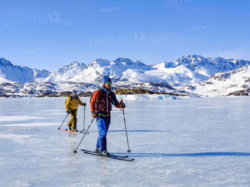 Ski mountaineers cross the frozen Kong Oscar Fjord
