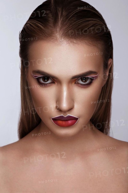 Beautiful caucasian woman with creative makeup and purple lips. Beauty face. Art makeup