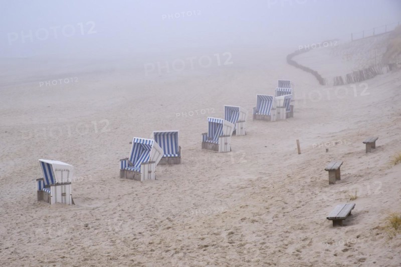 Empty beach chairs on a sandy beach