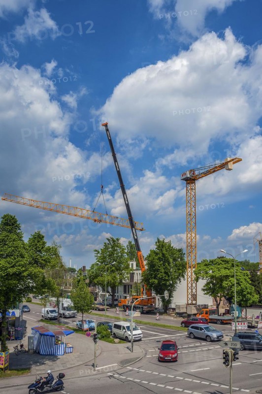 A construction crane is erected with a truck-mounted crane