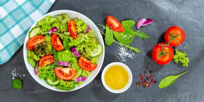 Mixed salad with fresh tomatoes healthy eating food from above banner on slate in Stuttgart