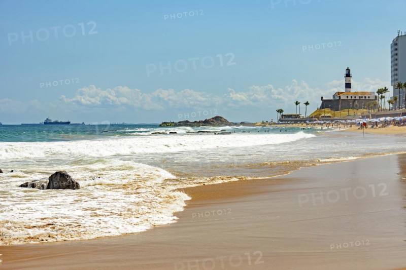 Barra beach buildings and lighthouse seen from afar with the summer sun of Salvador in Bahia