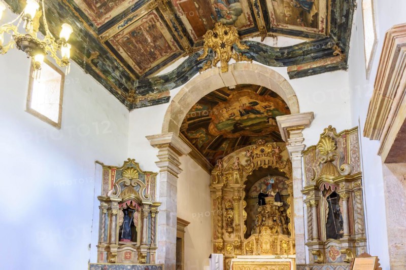 Interior and altar of a brazilian historic ancient church from the 18th century in baroque architecture with details of the walls in gold leaf in the city of Tiradentes
