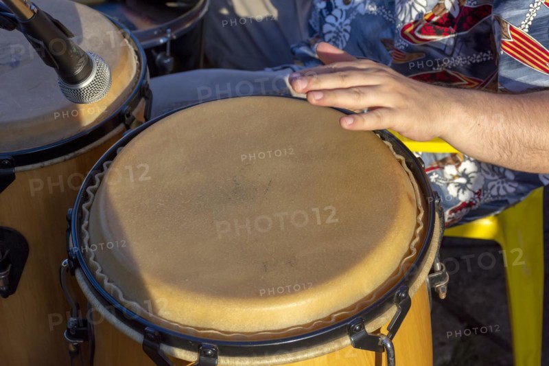 Detail of man playing atabaque during party at the carnival of the city of Belo Horizonte