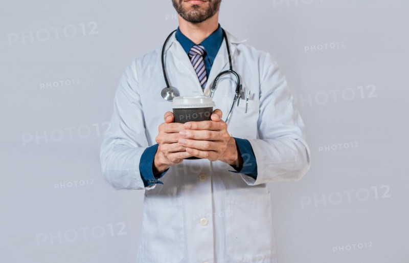 Doctor hands holding paper coffee. Doctor holding takeaway coffee on isolated background