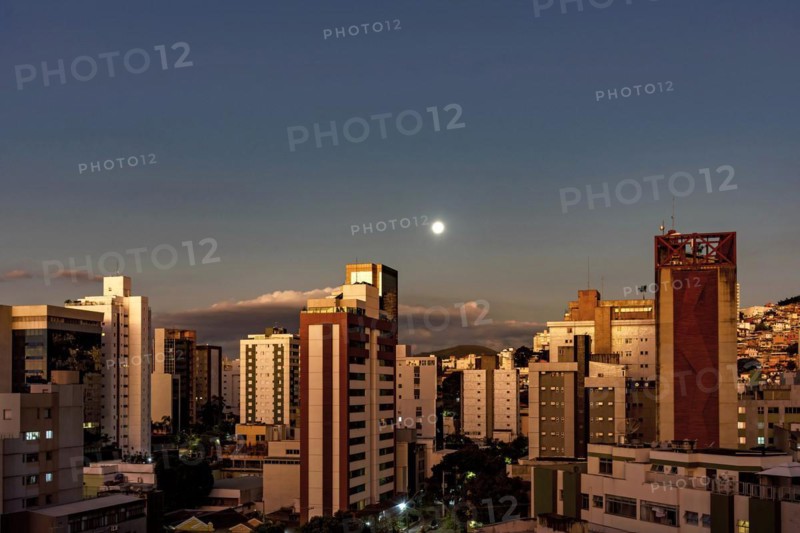 City of Belo Horizonte in the southeastern region of Brazil seen at dusk with the full moon over the buildings