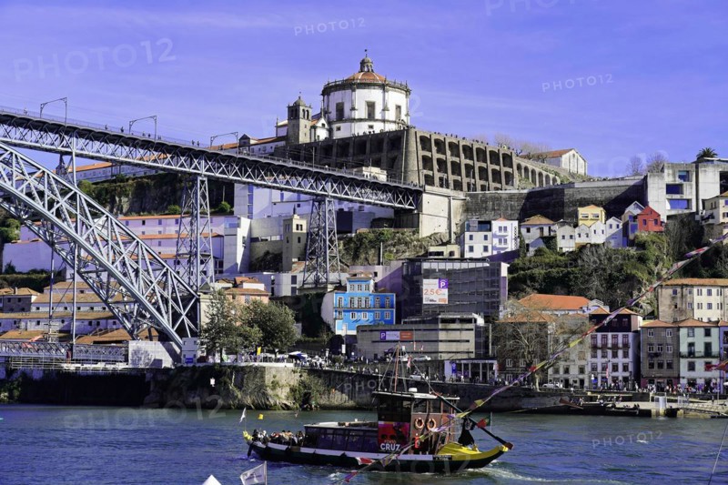 View of the Dom Luis I bridge over Douro River and terracota rooftops