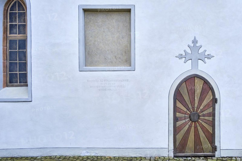 Arched door with cross on the top of the arch