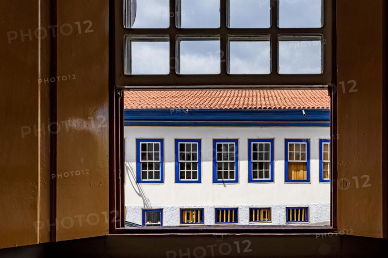 Old colonial style houses seen through a wooden window in the historic town of Diamantina in Minas Gerais