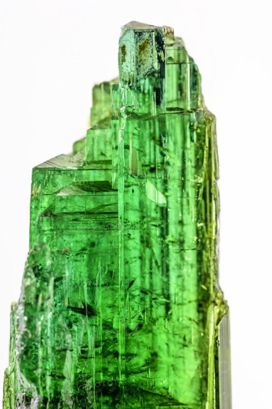 Brazilian green tourmaline raw crystal with white background
