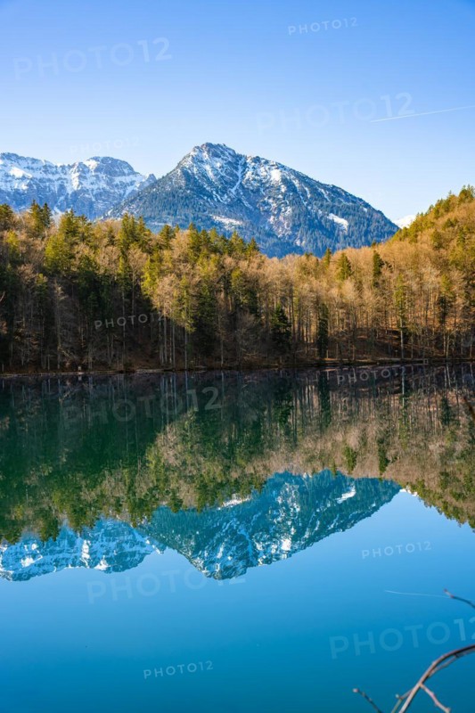 View over the green lake with mountain in the background