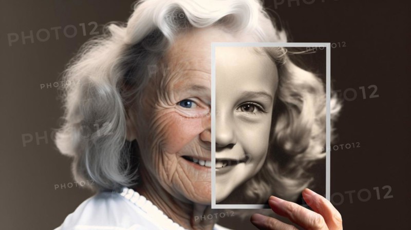 Elderly woman with wrinkled skin portrait holding A photo of herself as A young girl with perfect skin