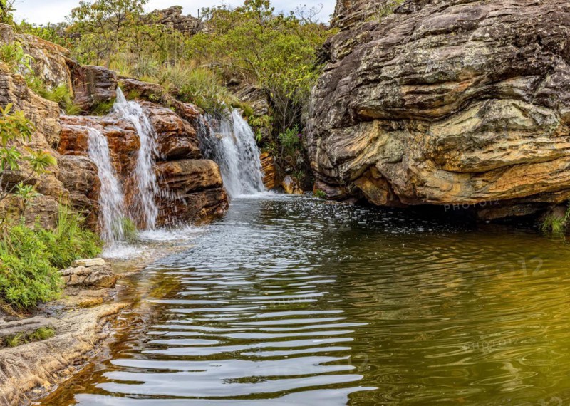 Waterfall among the vegetation and strong rocks of the Biribiri environmental reserve in Diamantina
