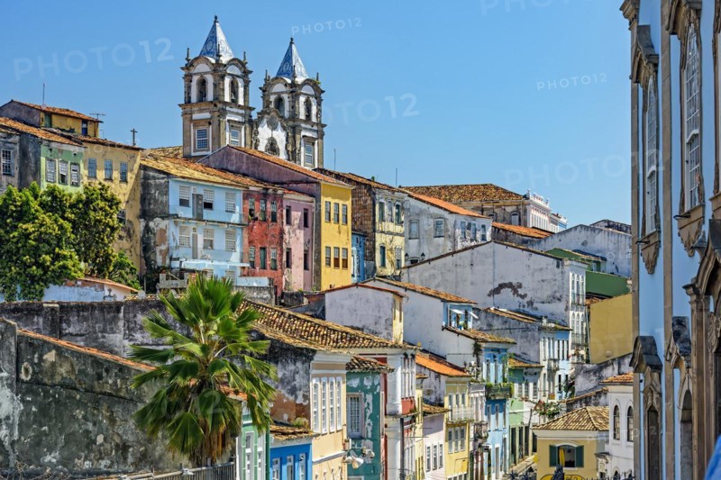 Colorful houses facades and historic church towers in baroque and colonial style with blue sky in the famous Pelourinho neighborhood of Salvador