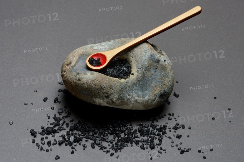 Black Hawaiian salt on spoons and in hollowed stone
