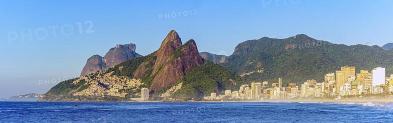 Panoramic image of early morning on Ipanema beach in Rio de Janeiro still empty with its buildings and the surrounding mountains