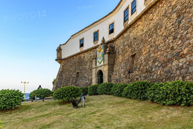 Facade of the old and historic fort and Barra lighthouse at afternoon in the city of Salvador