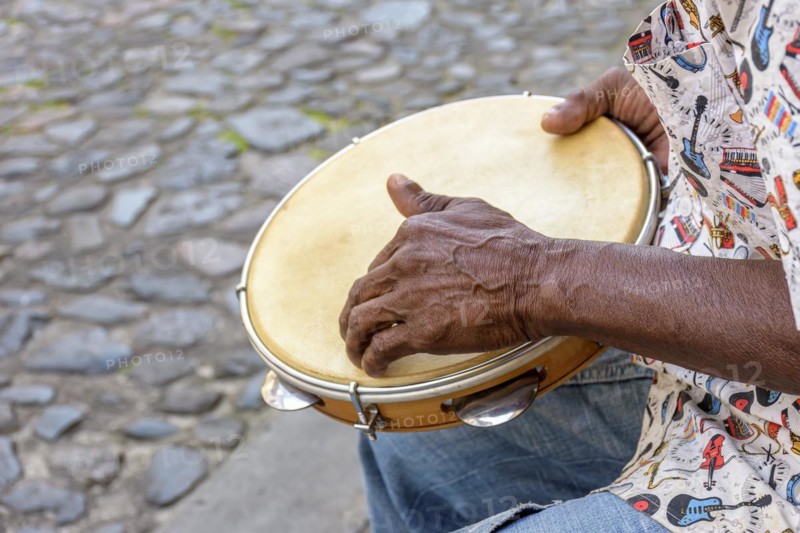Brazilian samba performance with musician playing tambourine in the streets of Pelourinho