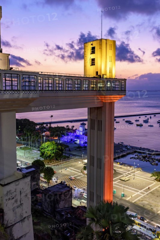 Facade of the famous Lacerda elevator illuminated at night of the city of Salvador in Bahia with the sea in background