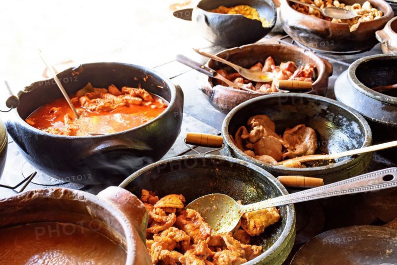 Traditional Brazilian food being prepared in clay pots and in the old and popular wood stove