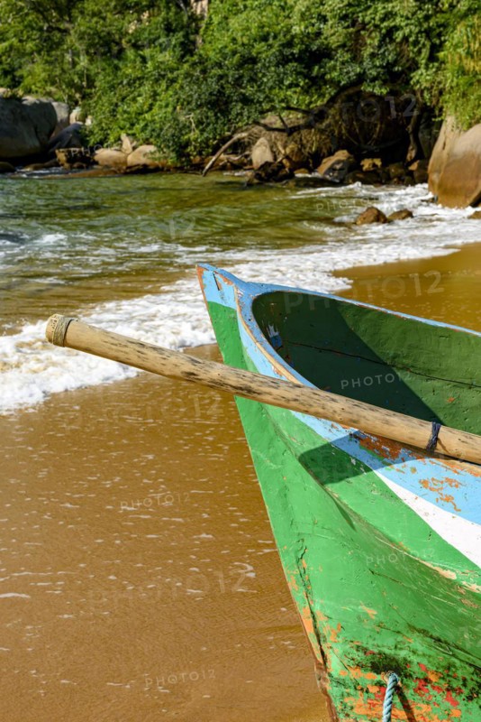 Rowing fishing boat on the shore of the unspoiled beach of Ilha Grande