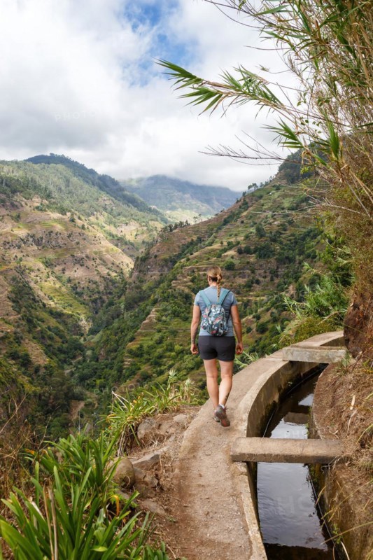 Young woman hiking along the Levada Nova hiking trail on Madeira Island