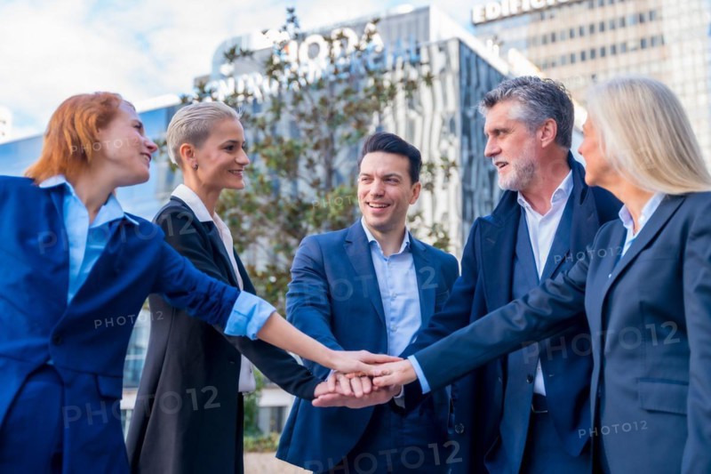 Successful Senior Executives High-Five in Celebration of Teamwork and Achievement