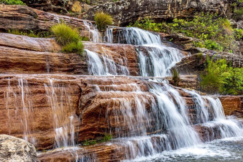 Water blur on beautiful and small waterfall among the rocks and vegetation of the Biribiri environmental reserve in Diamantina