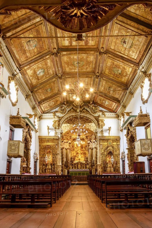 Interior and altar of a brazilian historic ancient church from the 18th century in baroque architecture with details of the walls in gold leaf in the city of Tiradentes