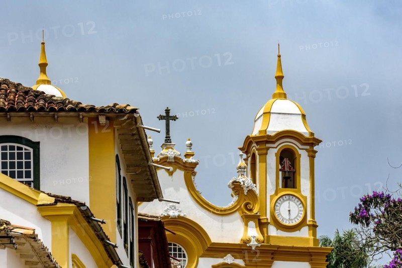 Facade of historic colonial style house and church in the famous city of Tiradentes in Minas Gerais