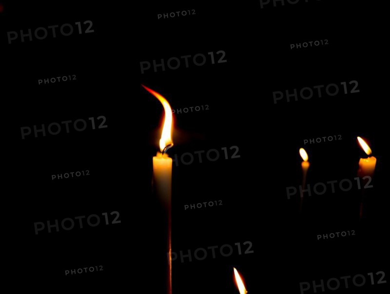 Lit candles in the dark