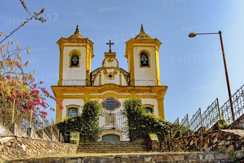 Bottom view of ancient stairs and historic church of 18th century colonial architecture on top of the hill in the city of Ouro Preto in Minas Gerais