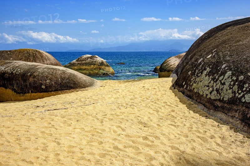 Paradisiacal beach of green and transparent waters surrounded by rocks in Ilha Grande