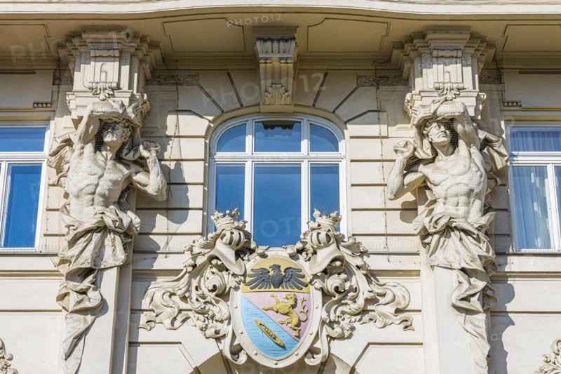 Stone figures as support on a historic facade