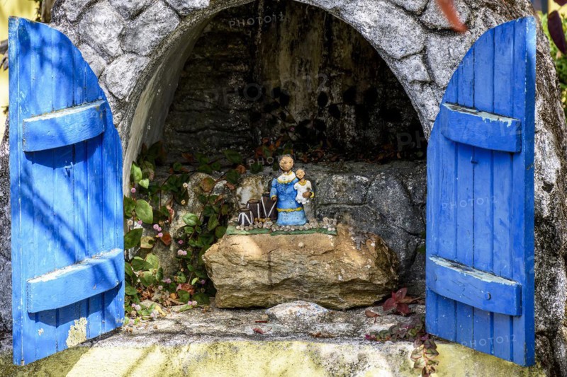 Small and simple altar with a figure of an Afro-American mother with her son and tribal drums honoring former slaves in the city of Lavras Novas in Minas Gerais
