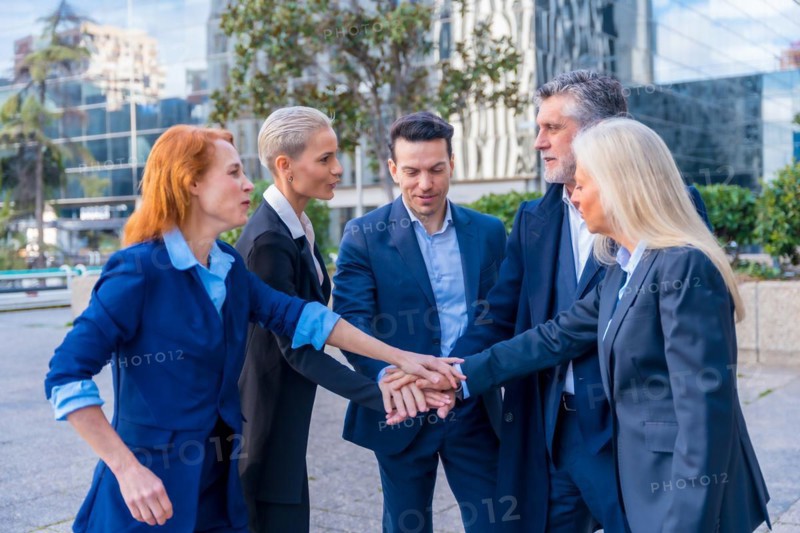 Senior Executives Unite with High-Five Gesture in Team Building and Collaboration