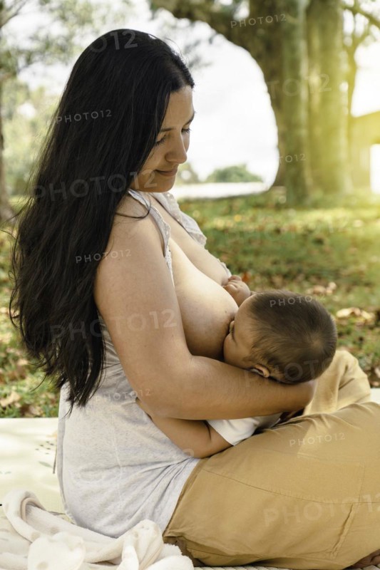 Mom and baby. It celebrates the act of breastfeeding as a nurturing and intimate moment between the two