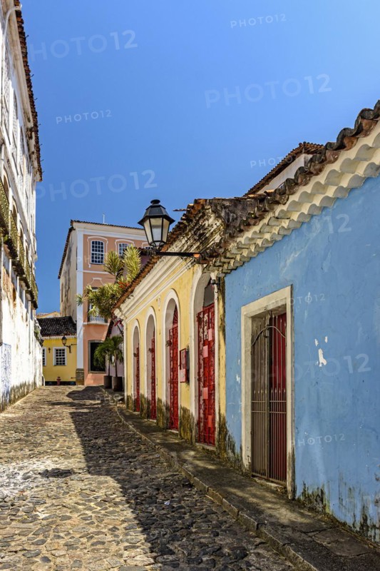 Colorful facades of colonial-style houses on a cobblestone street in the Pelourinho neighborhood of Salvador