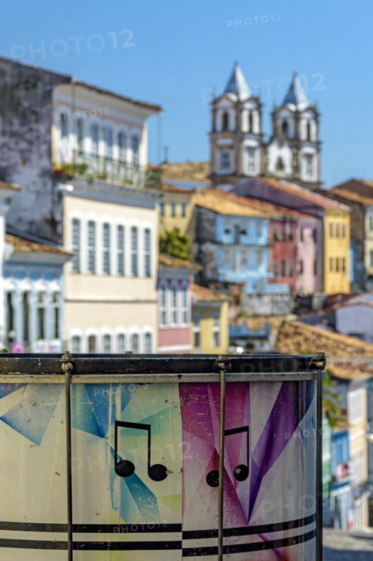 Colorful drum with the Pelourinho district with its historic and colorful houses and churches in the background in the city of Salvador