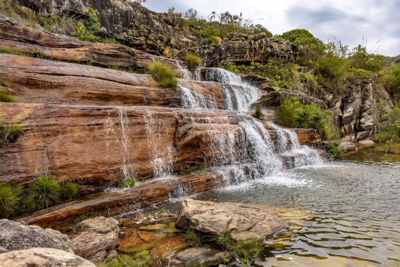 Cascade and river among the preserved vegetation of the Biribiri environmental reserve in Diamantina