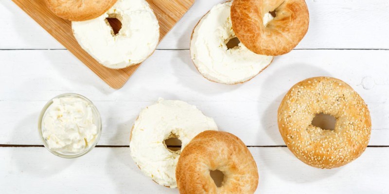 Bagel sandwich for breakfast topped with cream cheese on wooden board Panorama from above in Stuttgart