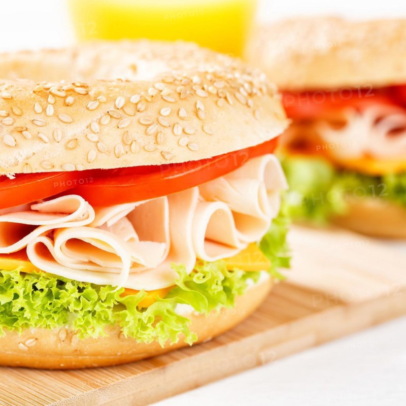 Bagel sandwich for breakfast topped with chicken ham close-up square in Stuttgart