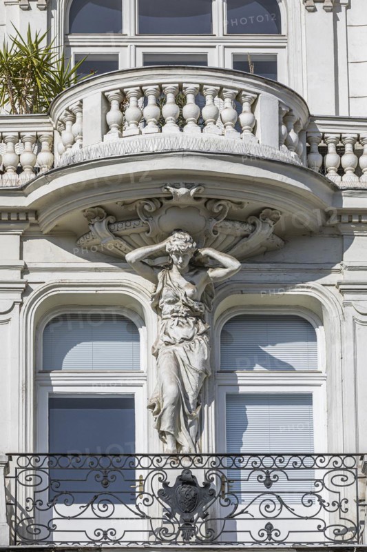 Baroque statue as support of a balcony on the left Wienzeile