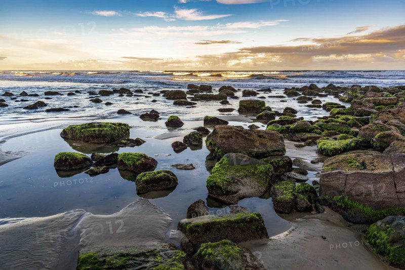 Quiet and deserted beach with rocks during sunset in the city of Torres in Rio Grande do Sul