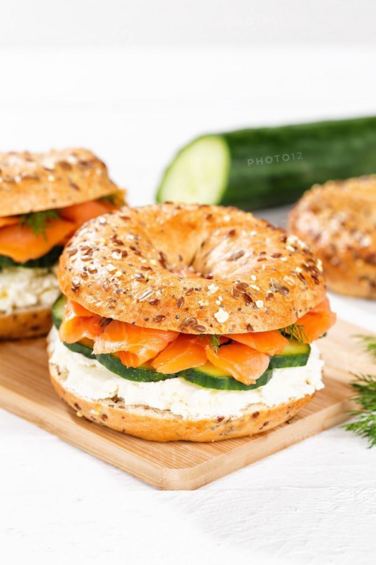 Bagel sandwich for breakfast topped with salmon fish on a board in Stuttgart