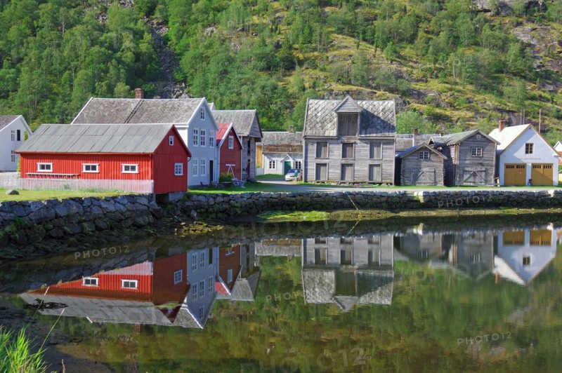 Wooden houses reflected in calm waters