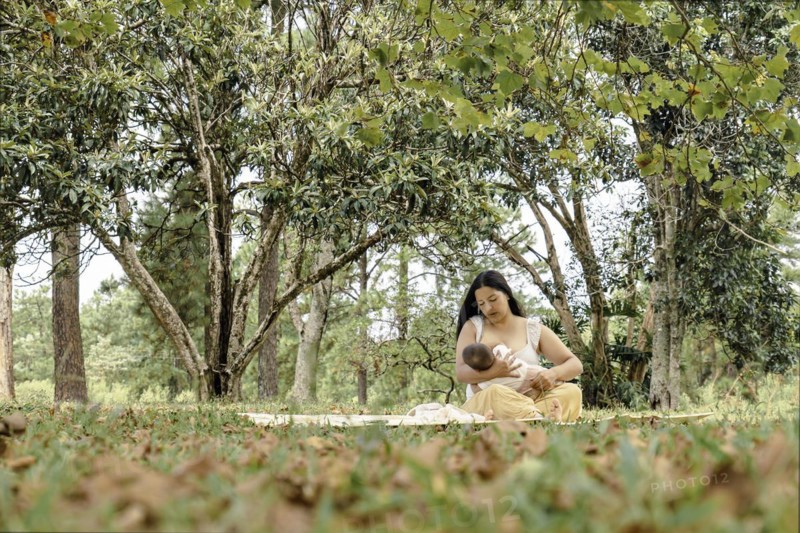 The mother is breastfeeding her daughter. Moment of motherhood