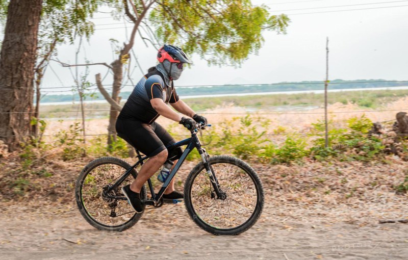 Lifestyle of a chubby cyclist on the road. Professional cyclist on a dirt road